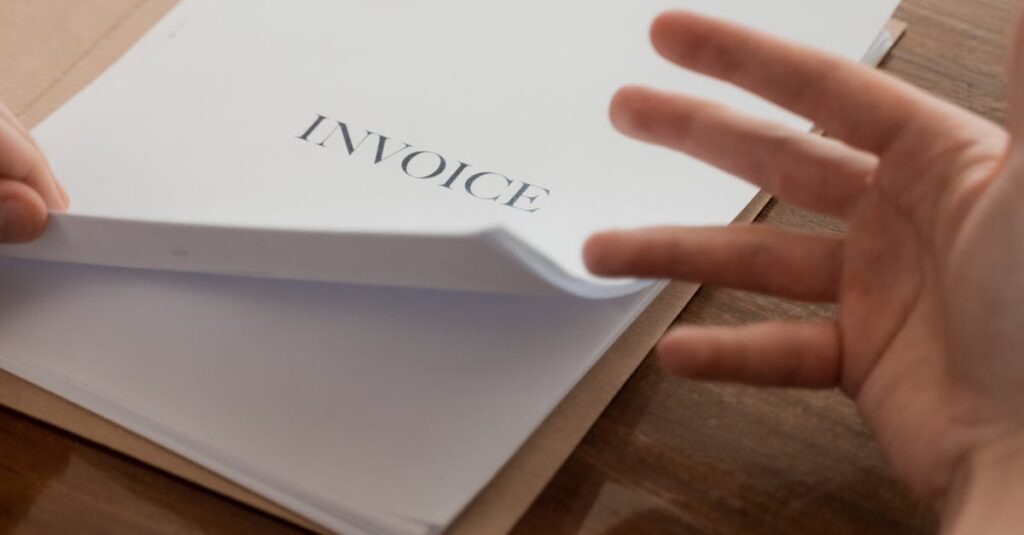 Businessman's hand going through invoices on a table, conveying business management concept.