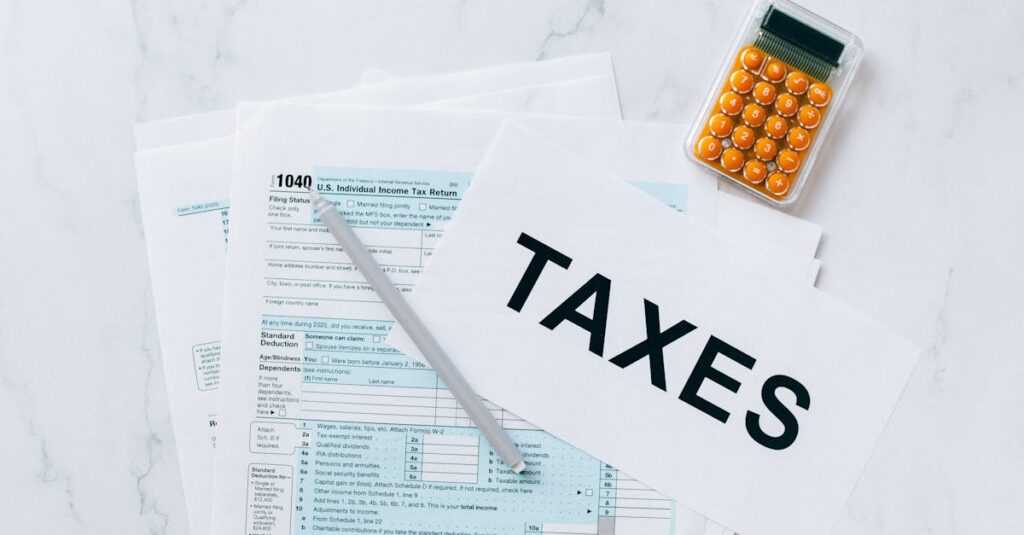 Top view of tax forms, a calculator, and pen for tax preparation.