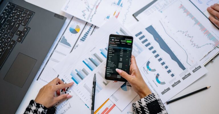 A top view on charts and smartphone in an office, showcasing data analytics.